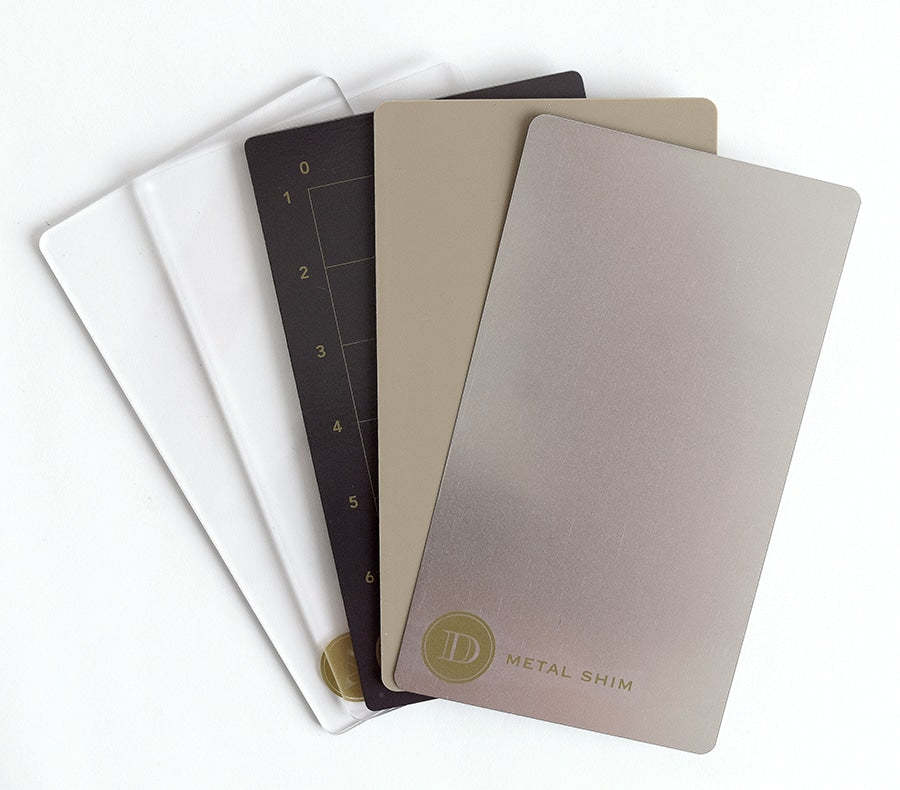 a group of four notebooks sitting on top of each other.