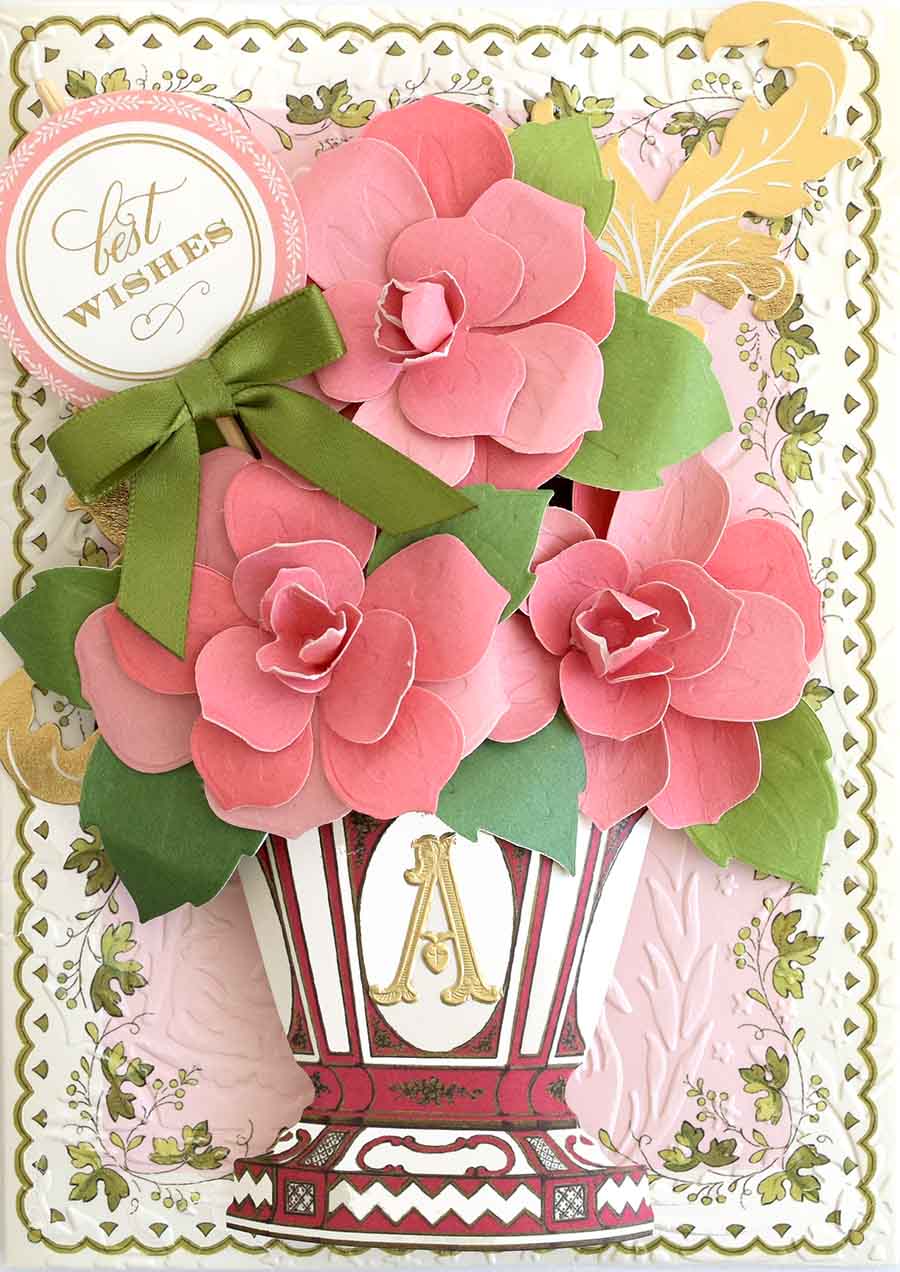a close up of a card with flowers in a vase.