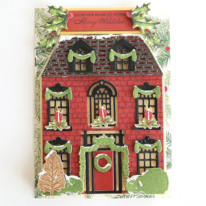 a christmas card with a gingerbread house.
