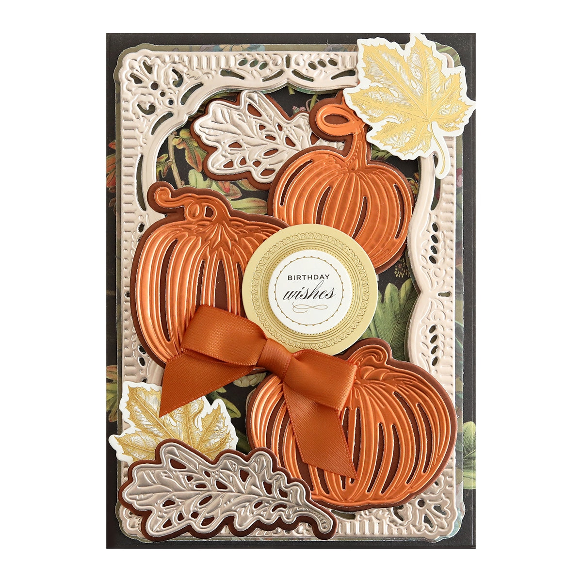 A card with Mini 3D Pumpkin& Leaf Dies and a bow.