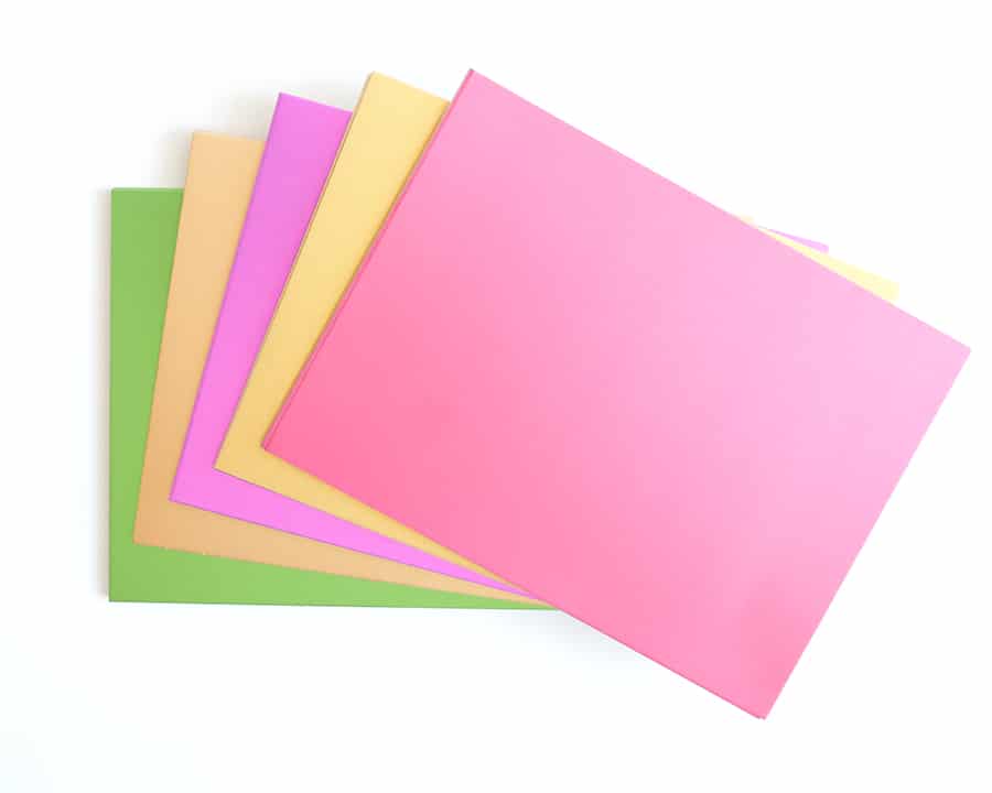 a pile of different colored paper on a white background.