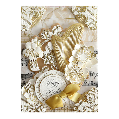 a close up of a card with gold and white decorations.