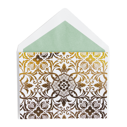 a white envelope with gold foil on a green background.