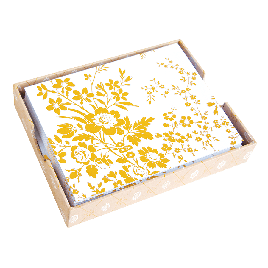 a yellow and white floral print on a wooden tray.