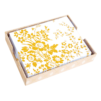 a yellow and white floral print on a wooden tray.