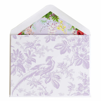 a white envelope with a purple floral design.