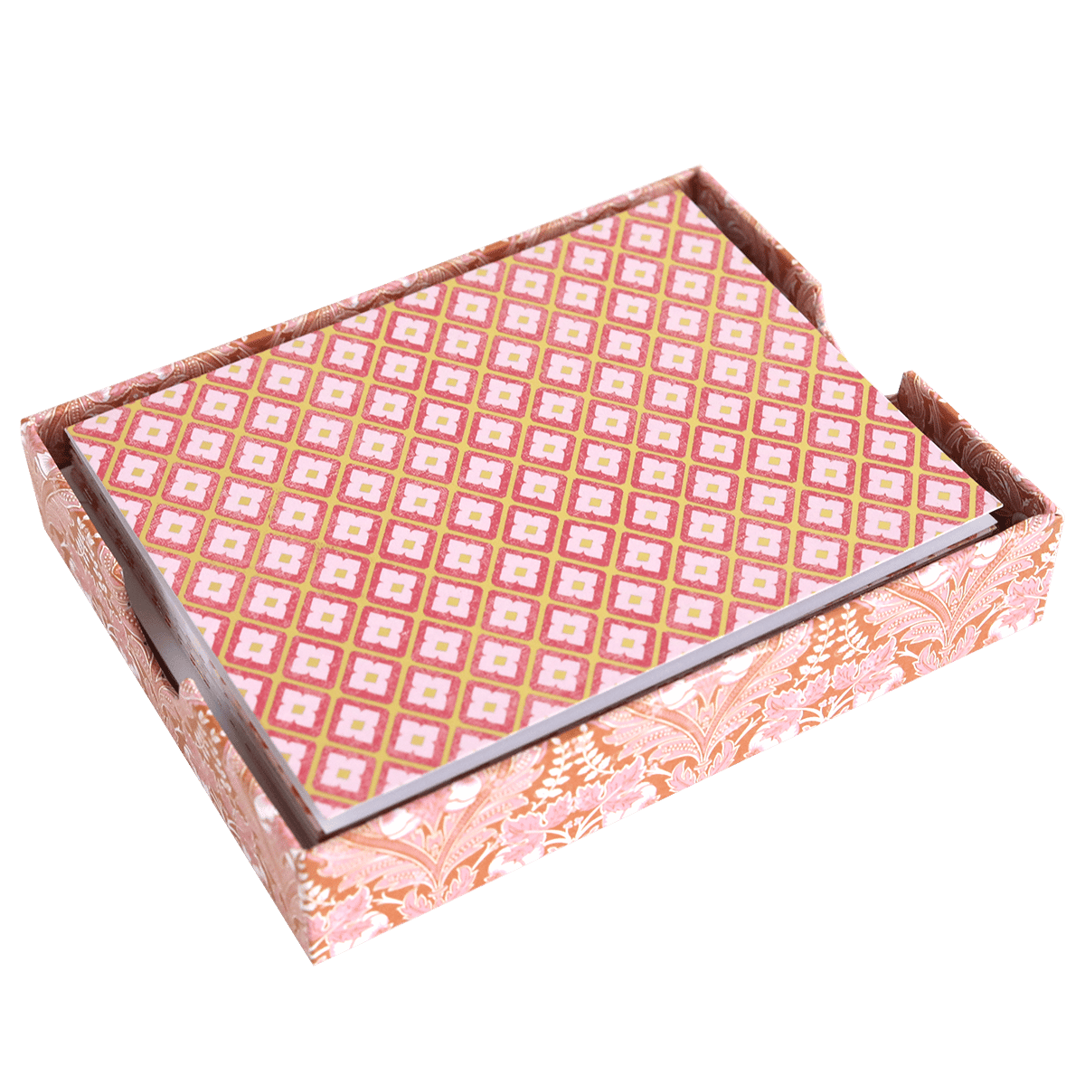 a pink and gold patterned box on a green background.