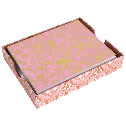 a pink and gold box with flowers on it.