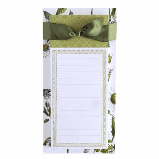 a notepad with a green bow on top of it.
