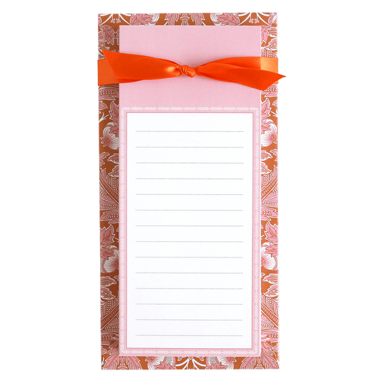 a notepad with a red bow on top of it.