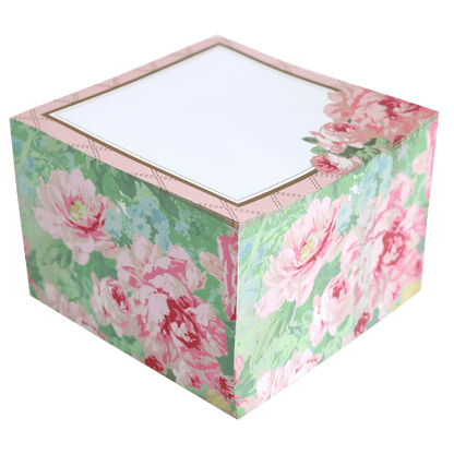 a pink and green flowered box with a white lid.