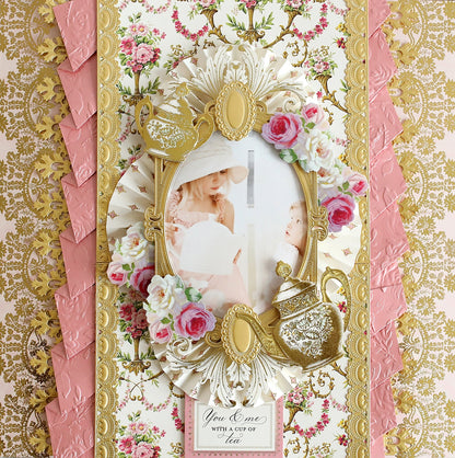 a pink and gold card with a picture of a baby.