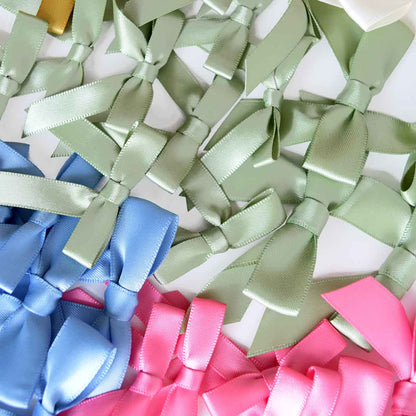 a bunch of different colored bows on a table.