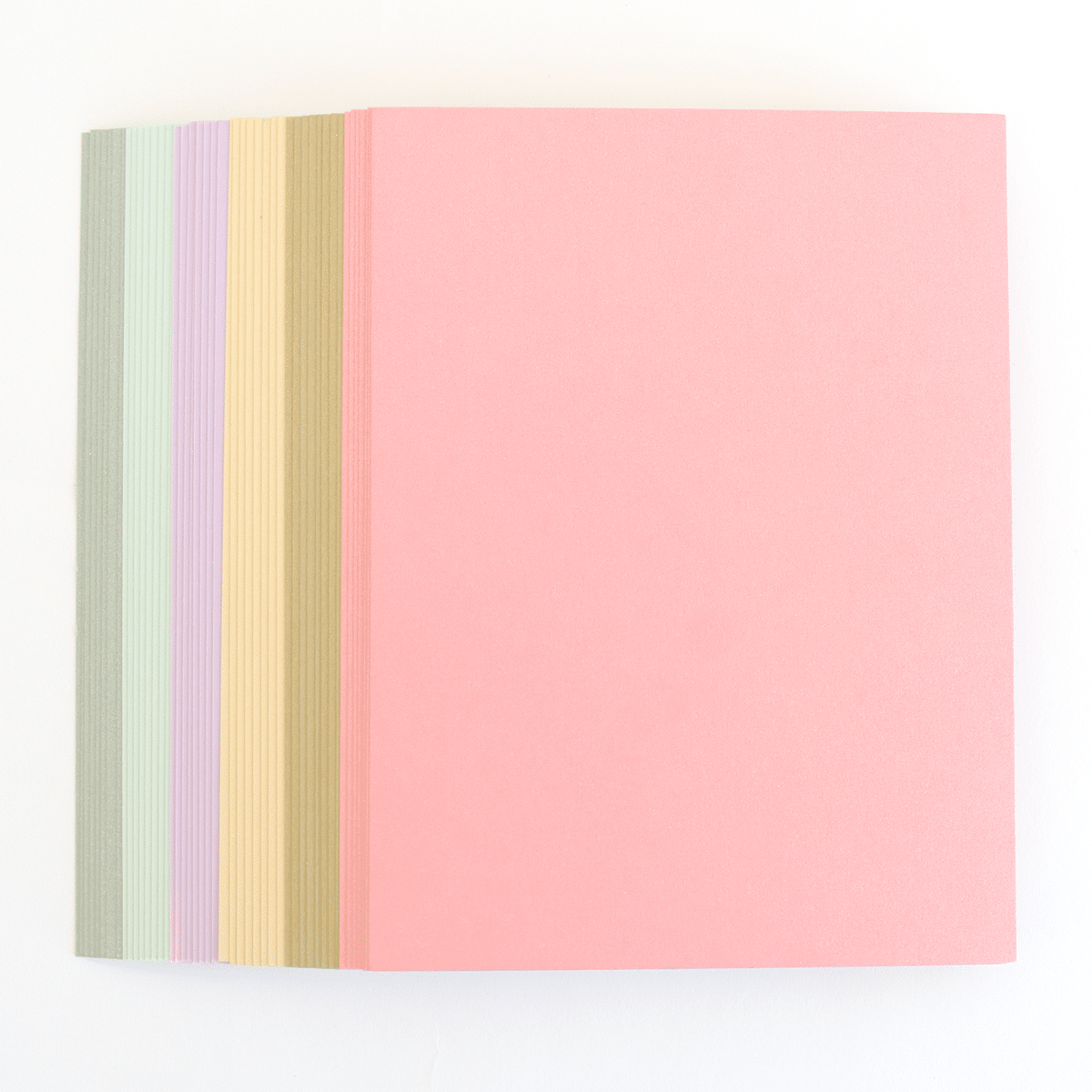 a pink, yellow, and green striped notebook on a white background.