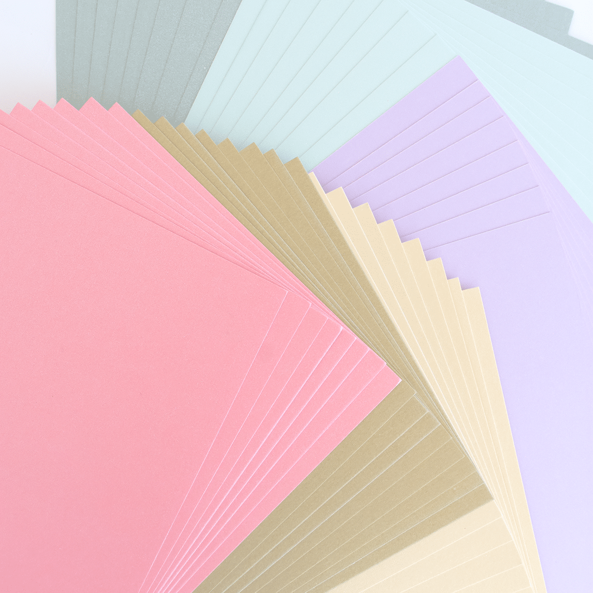 a bunch of different colors of paper on a table.