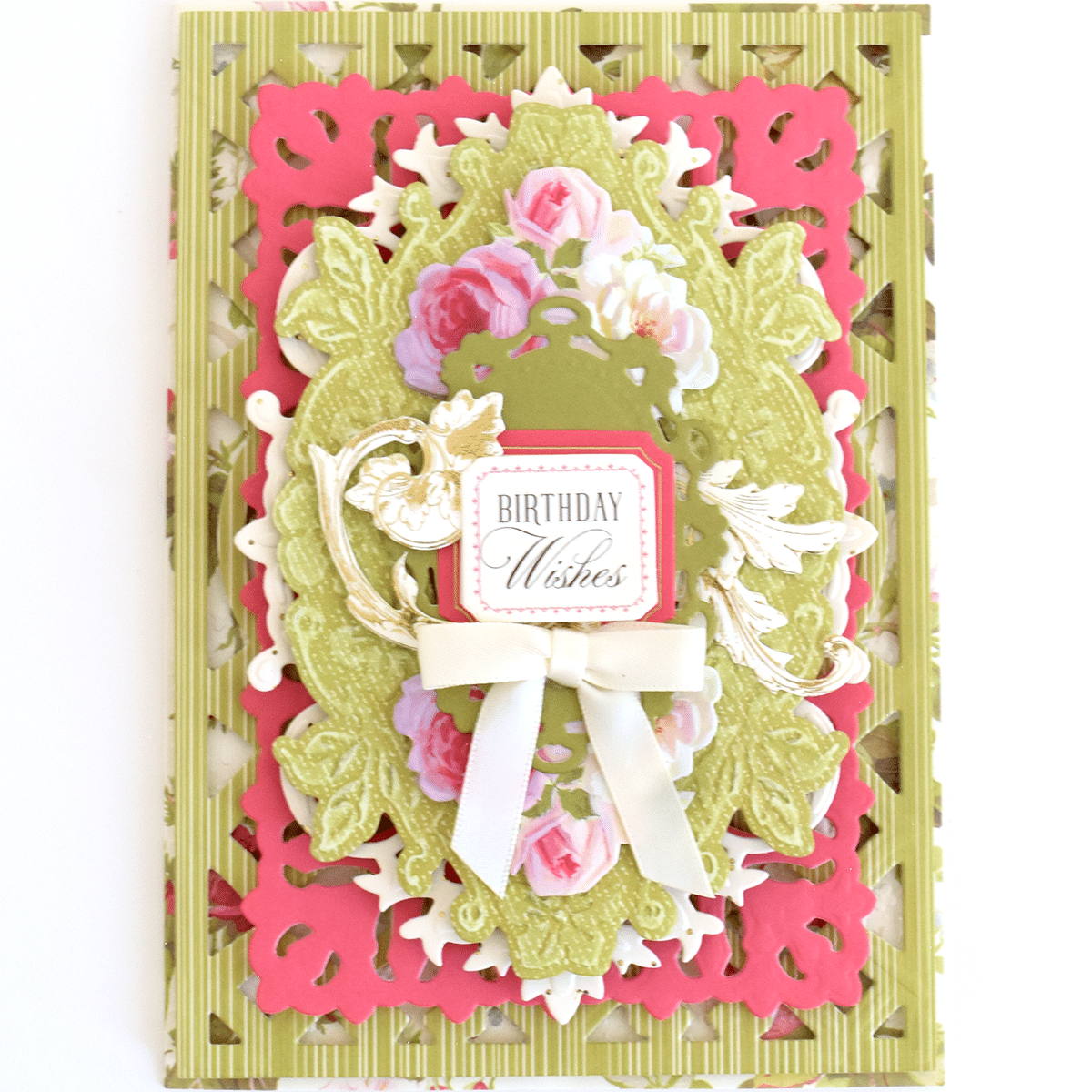 a birthday card with flowers and a bow.