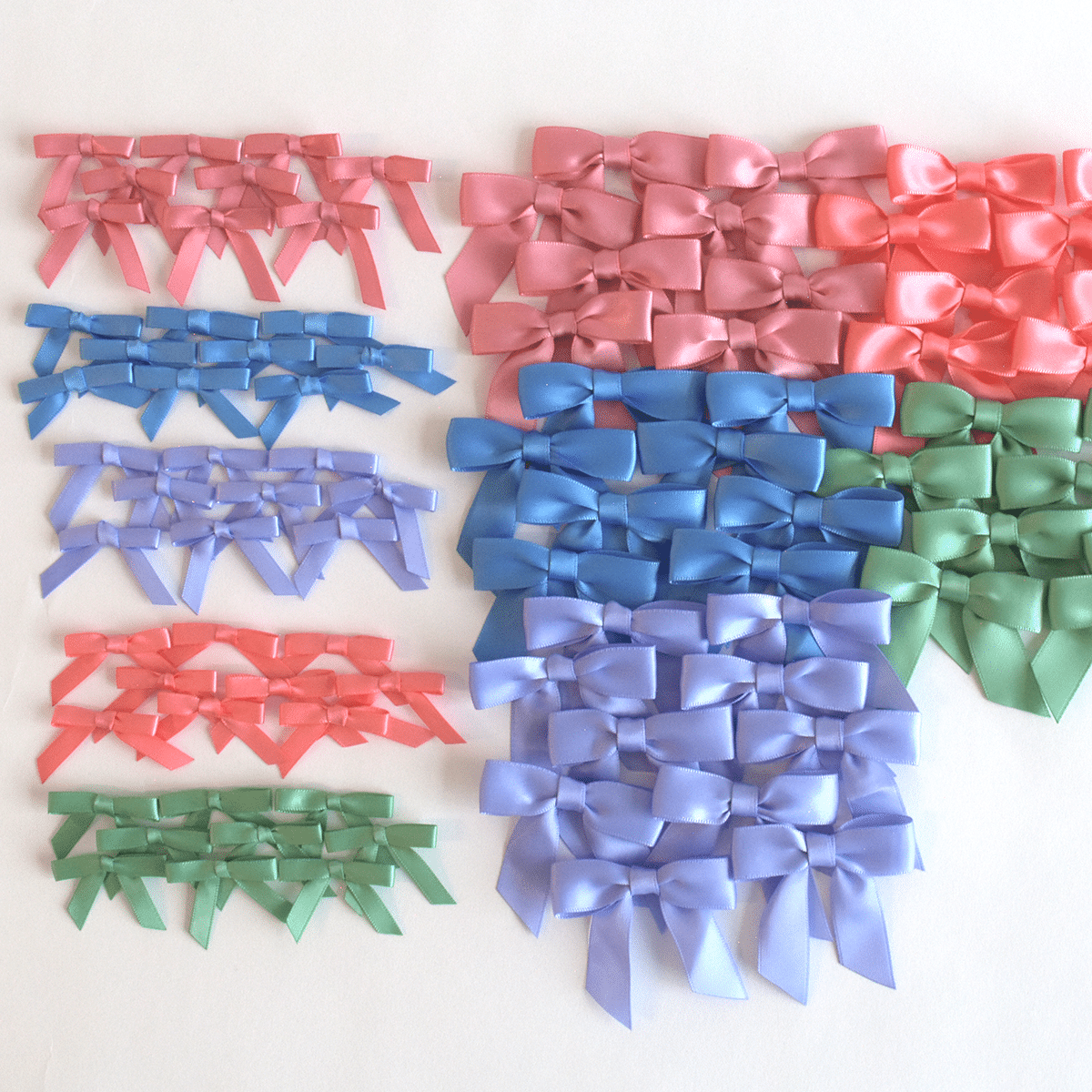 a group of different colored bows on a white surface.