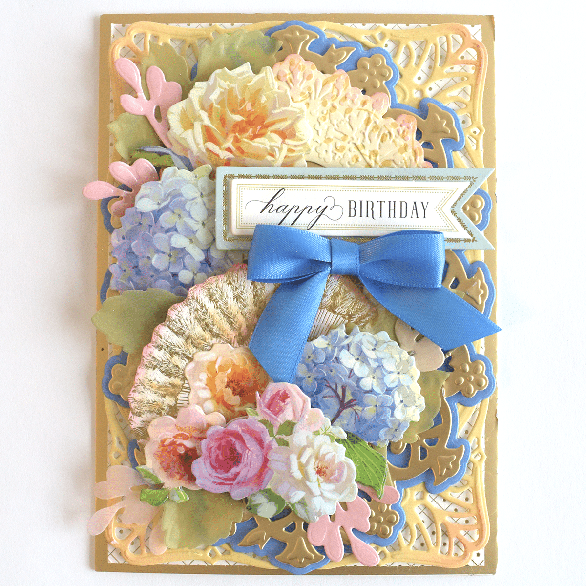 a happy birthday card with flowers and a blue ribbon.