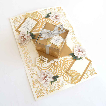 a card with a gift box and flowers on it.