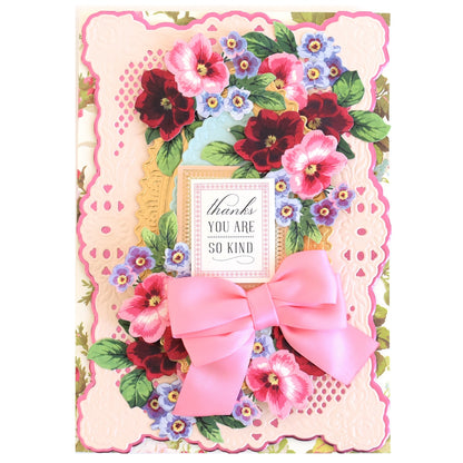 a card with a pink bow and flowers on it.