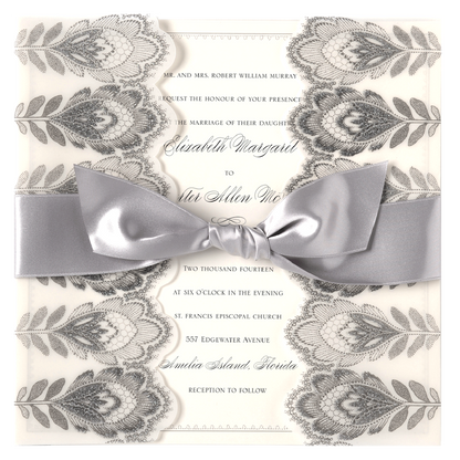 a wedding card with a silver bow on it.