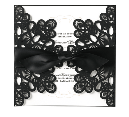 a black and white wedding card with a bow.