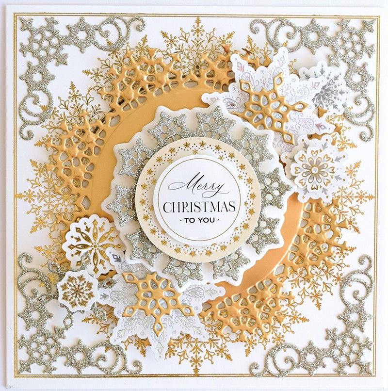 a white and gold christmas card with a snowflake design.