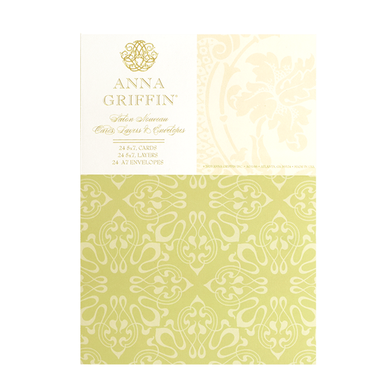 a green and white paper with a gold design on it.