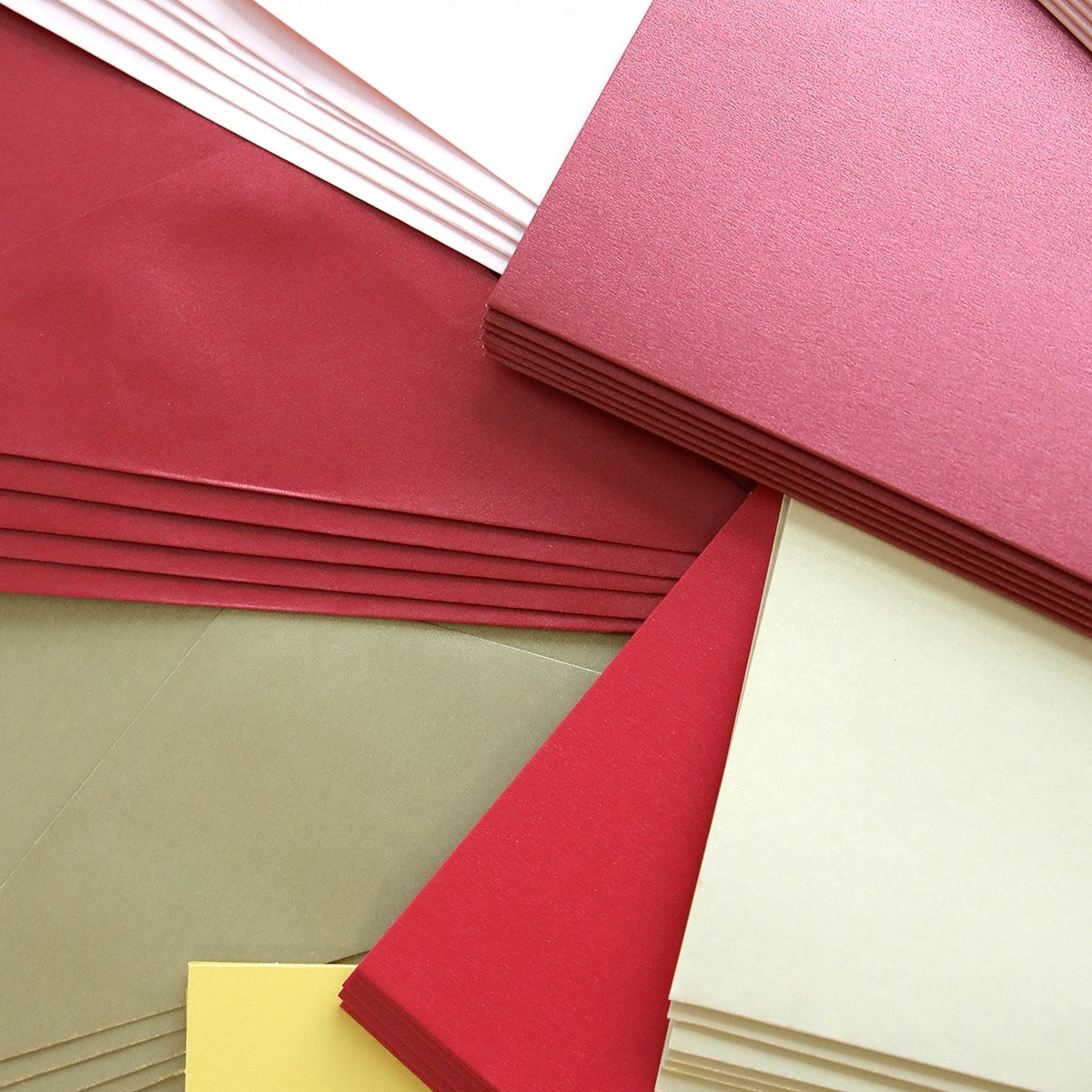 a pile of different colored papers sitting on top of each other.
