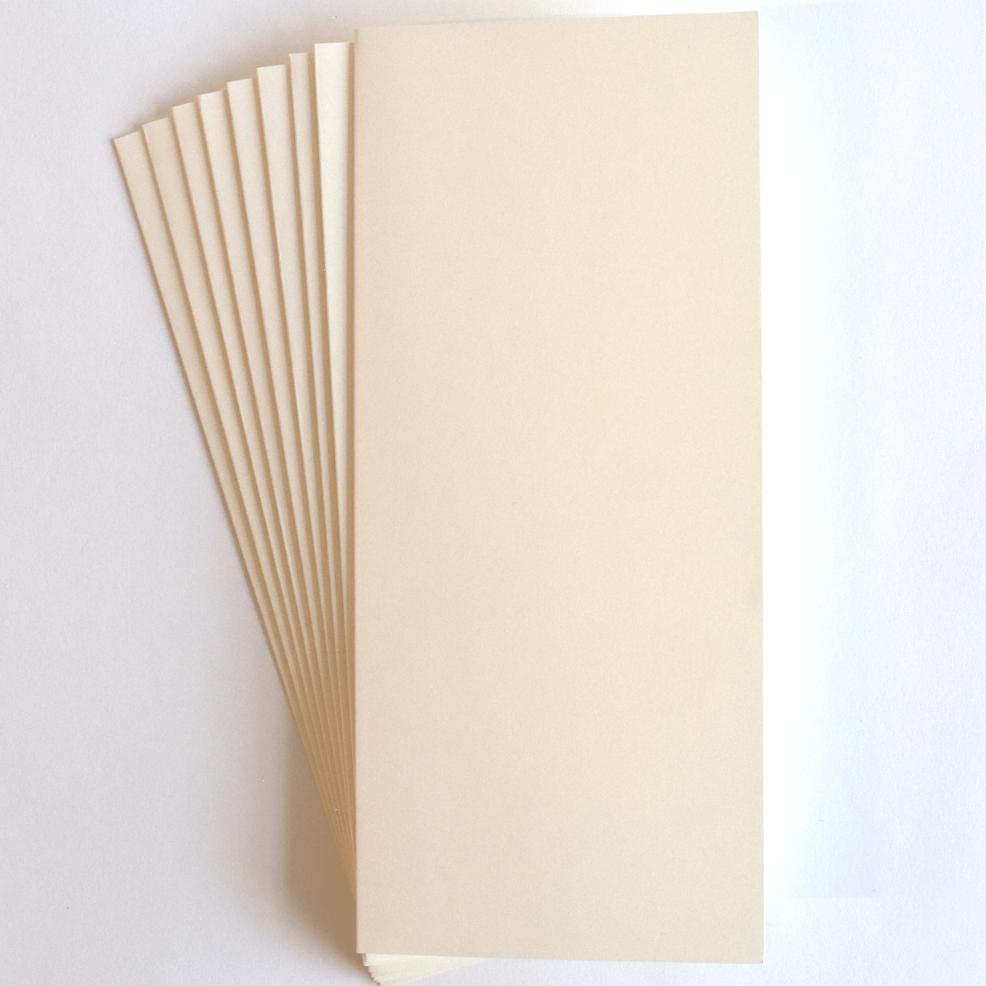 a stack of white paper sitting on top of a white table.