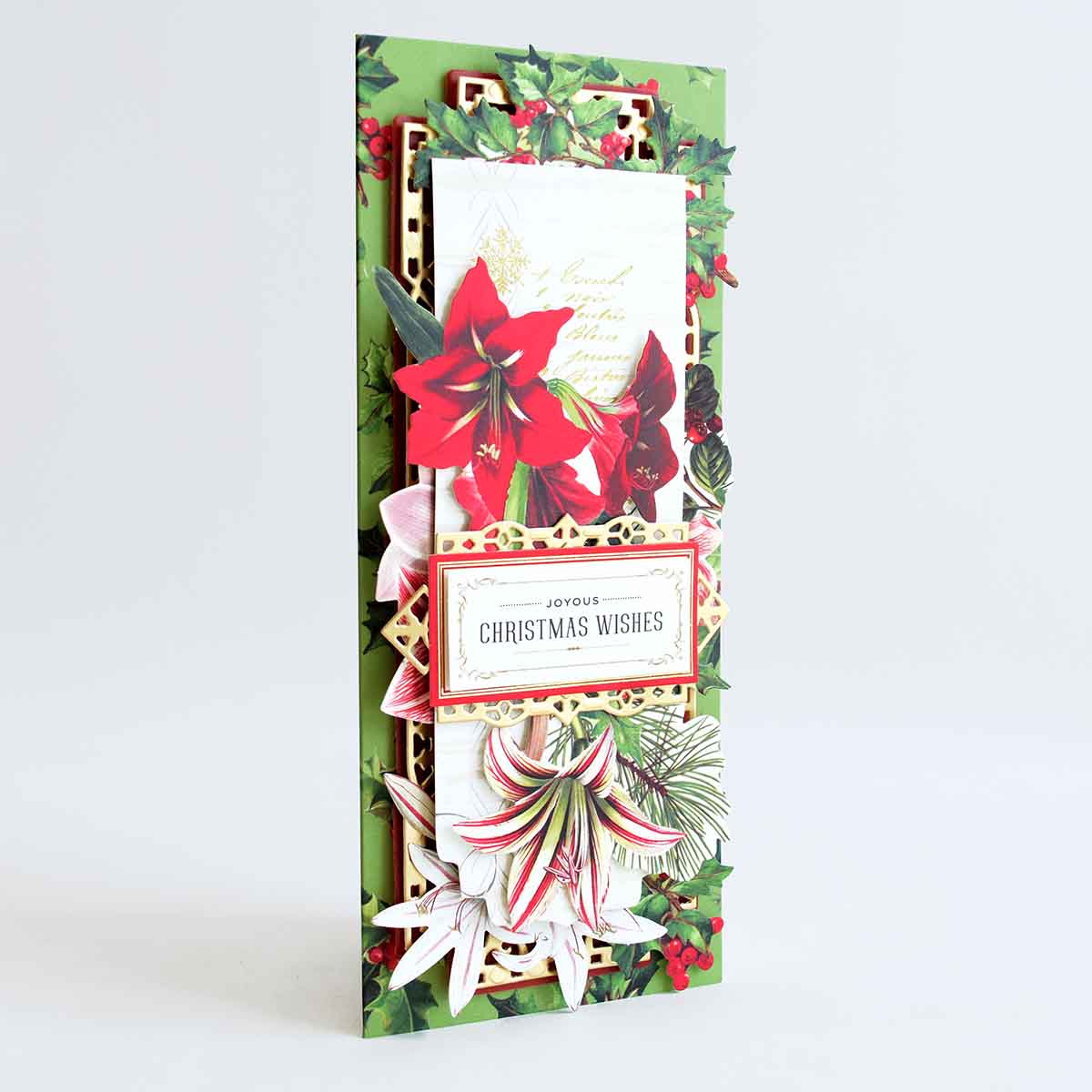 a christmas card with poinsettis and holly.