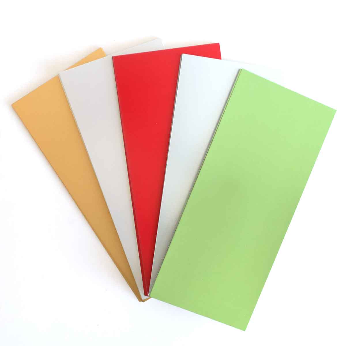 four different colors of paper on a white surface.
