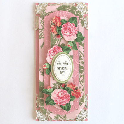 a greeting card with pink flowers on a pink background.