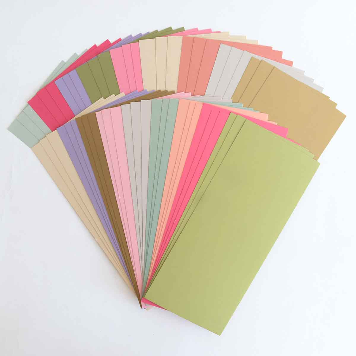 a bunch of different colored papers on a white surface.