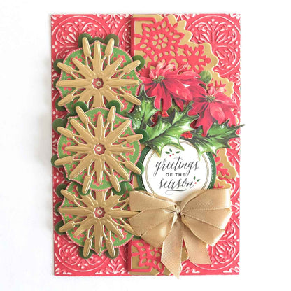 a red and green card with flowers and a bow.