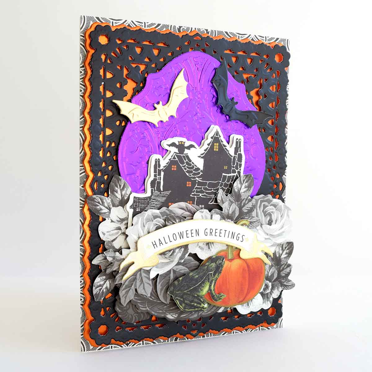 a halloween card with a bat and pumpkin.