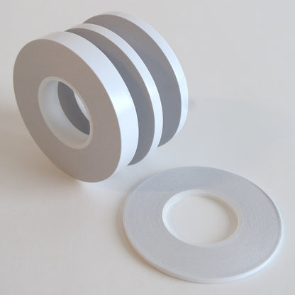a group of white and grey tape on a white surface.