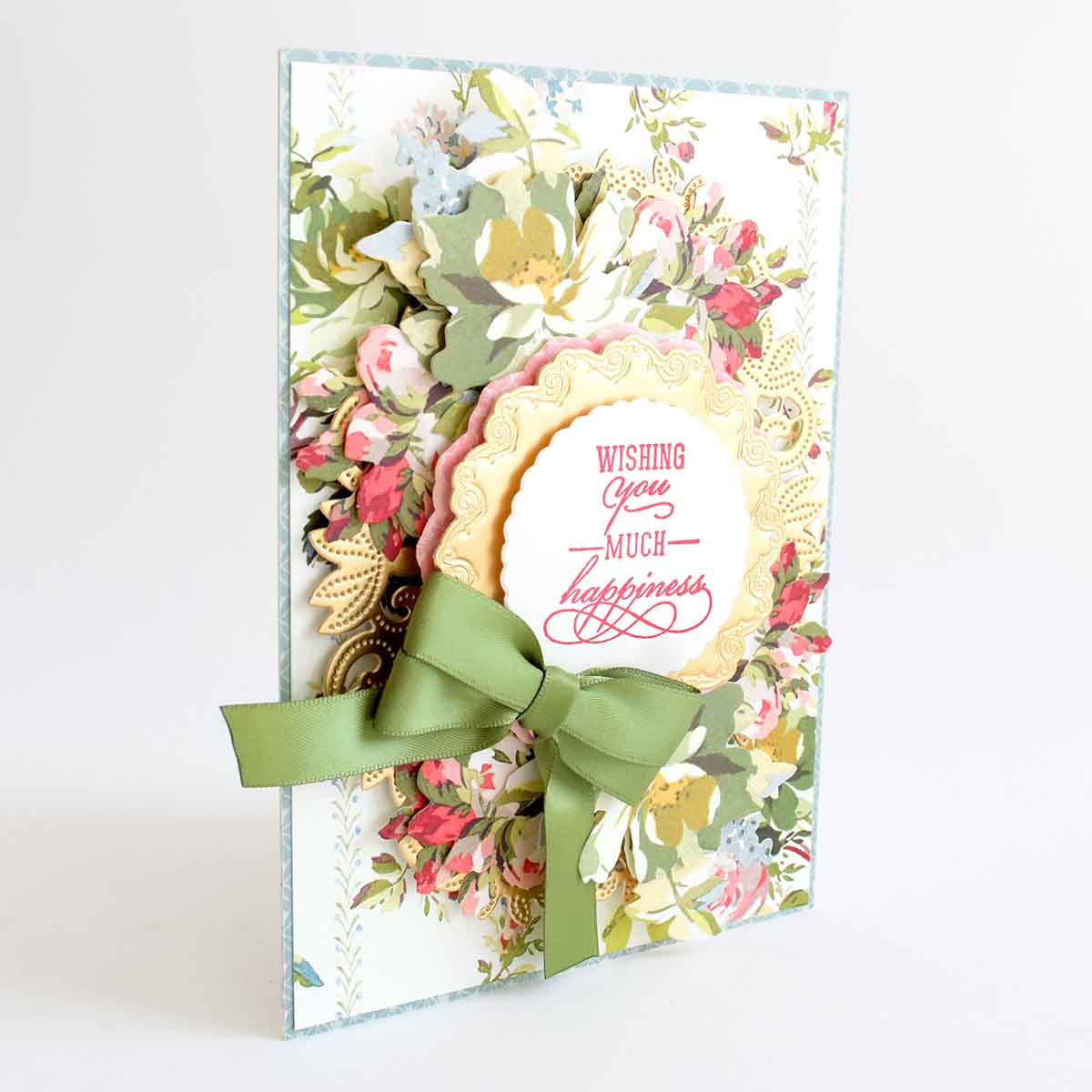 a close up of a greeting card with a green bow.