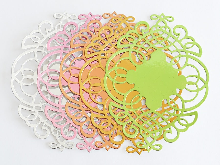 a group of paper cut outs sitting on top of a table.