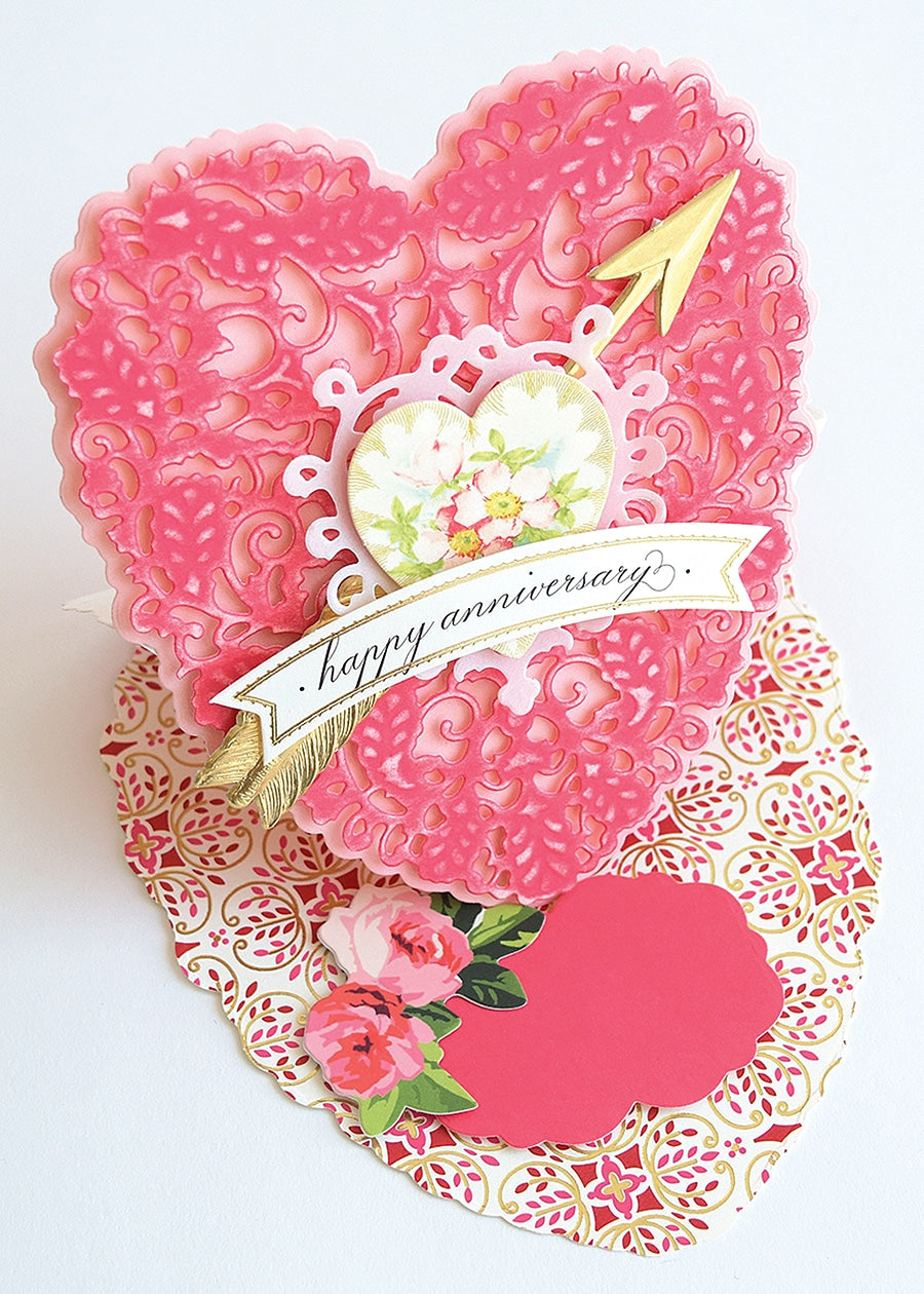 a heart shaped card with a happy anniversary message.