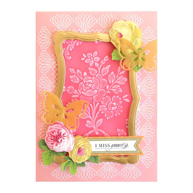 a pink and yellow card with flowers on it.