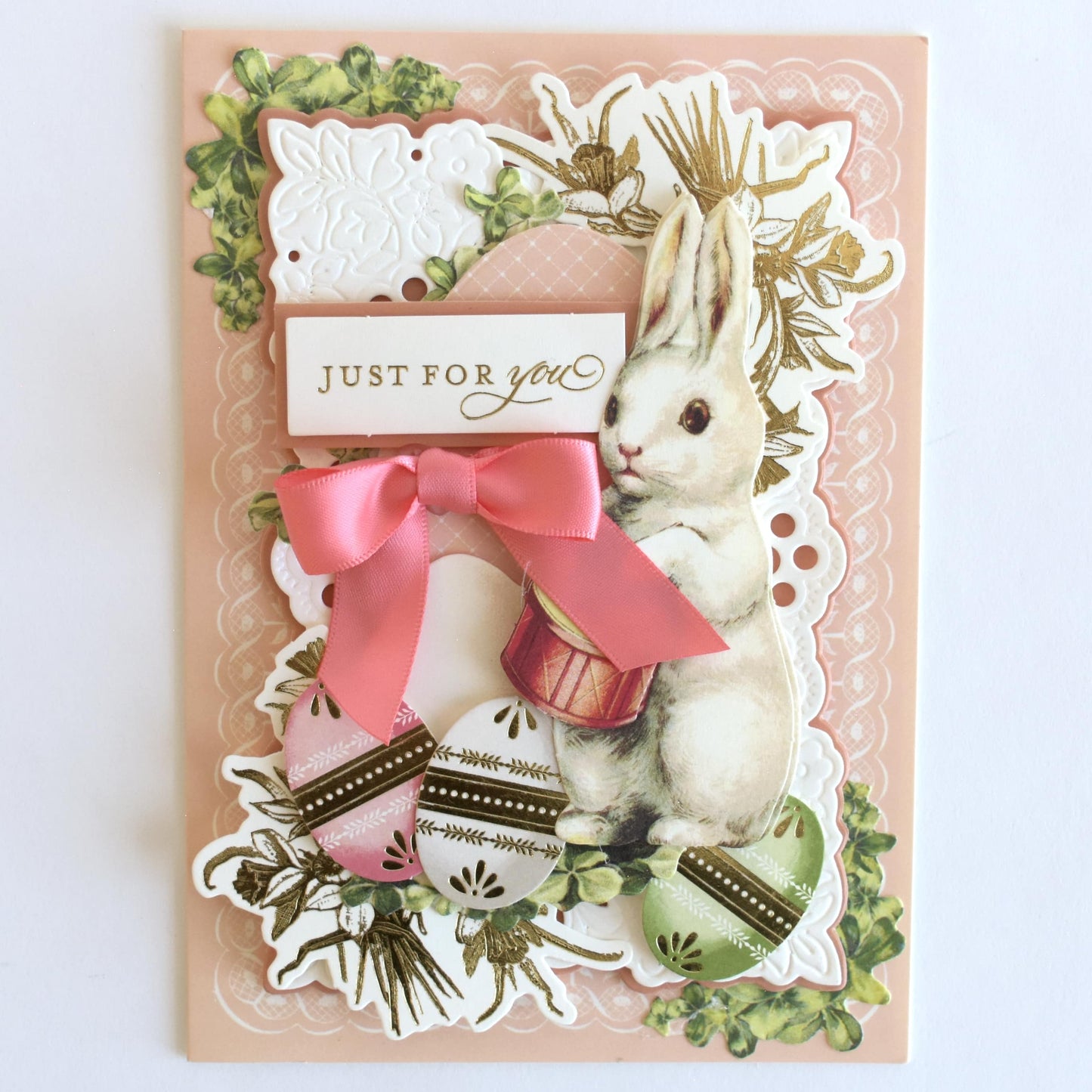 a card with a picture of a rabbit and a ribbon.