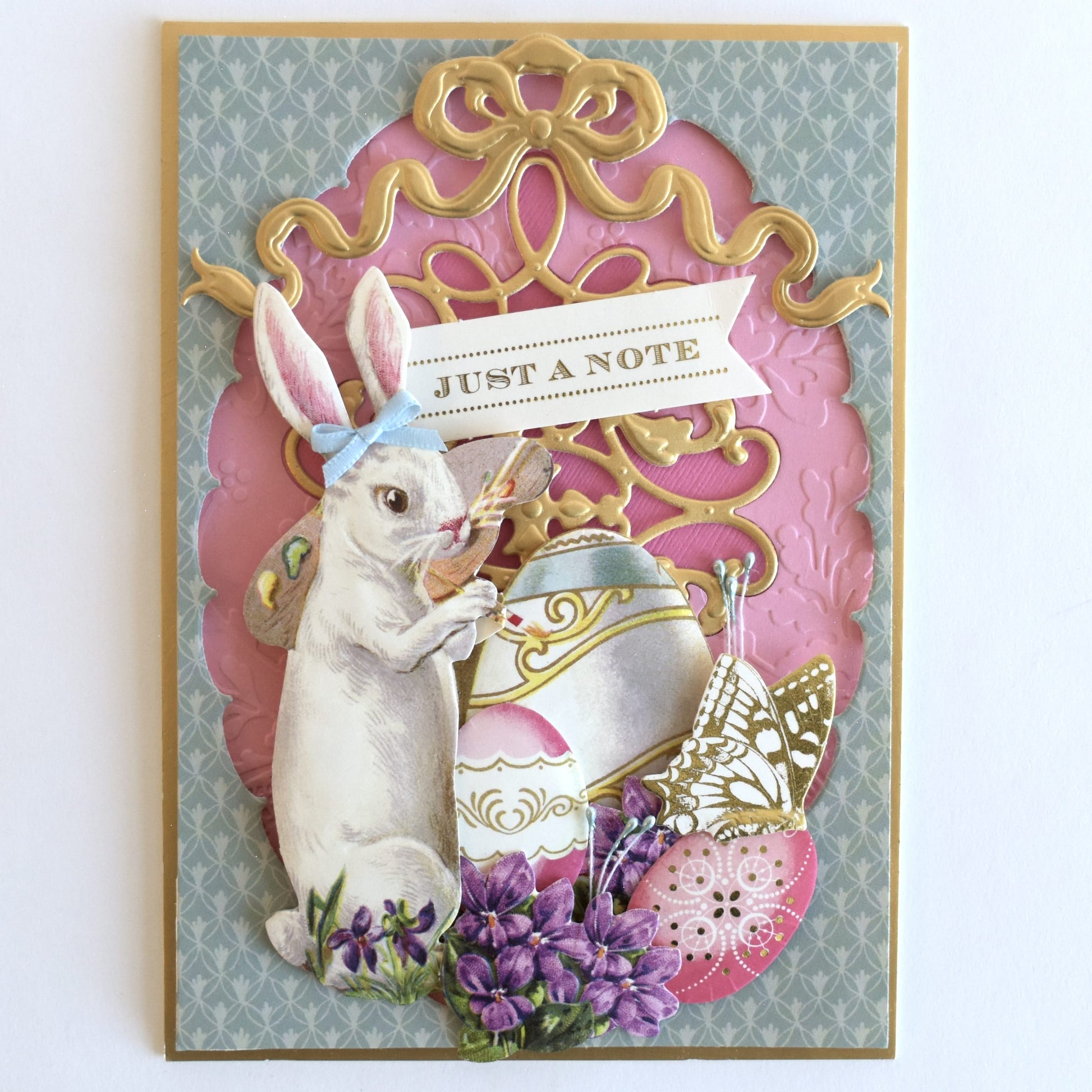a card with a bunny holding a basket of eggs.