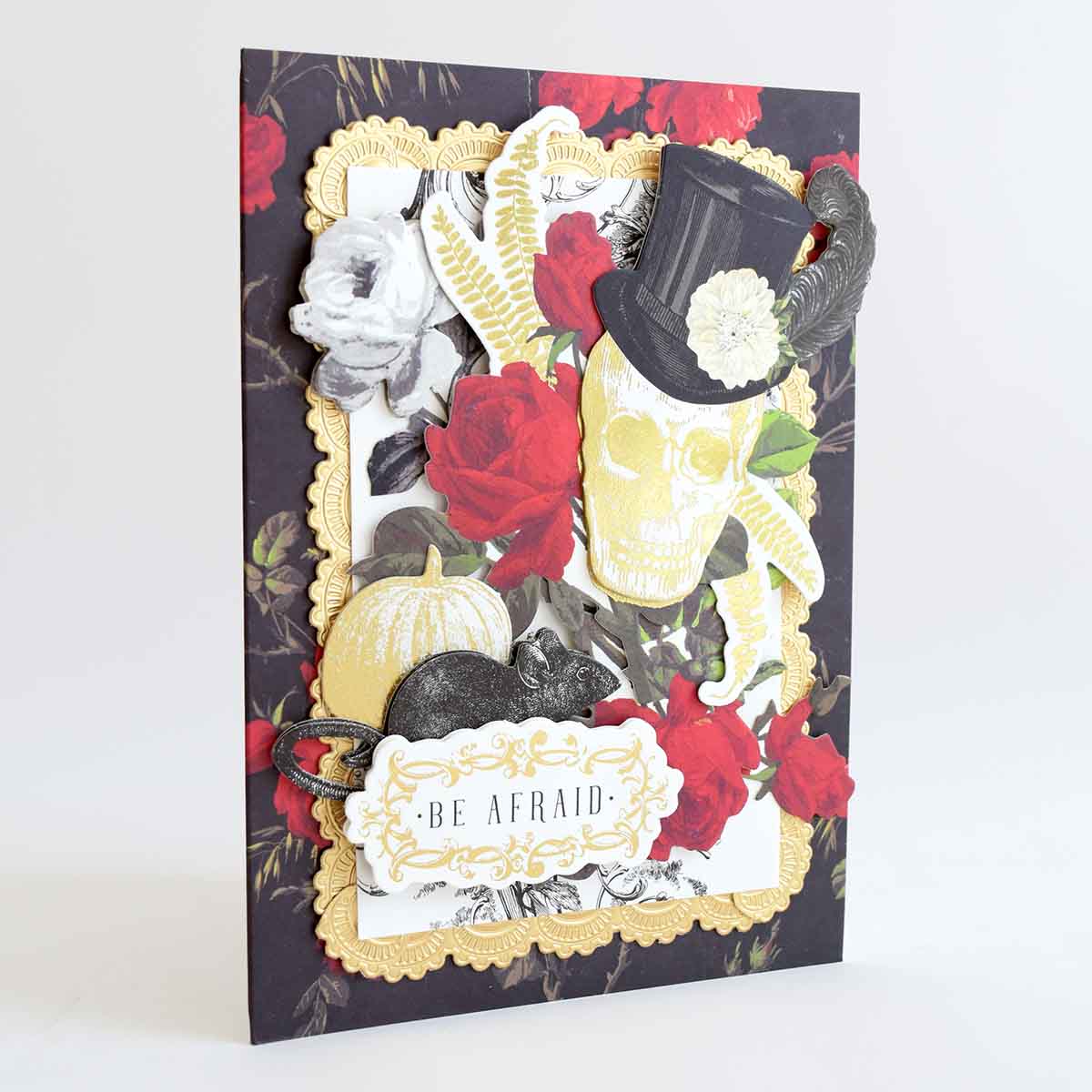 a card with a skull and roses on it.