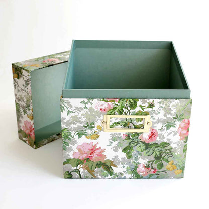 two boxes with flowers on them sitting next to each other.