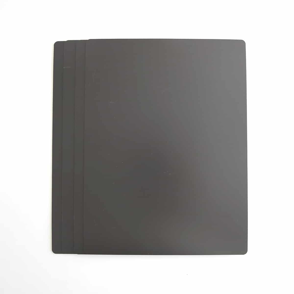 a black notebook sitting on top of a white table.
