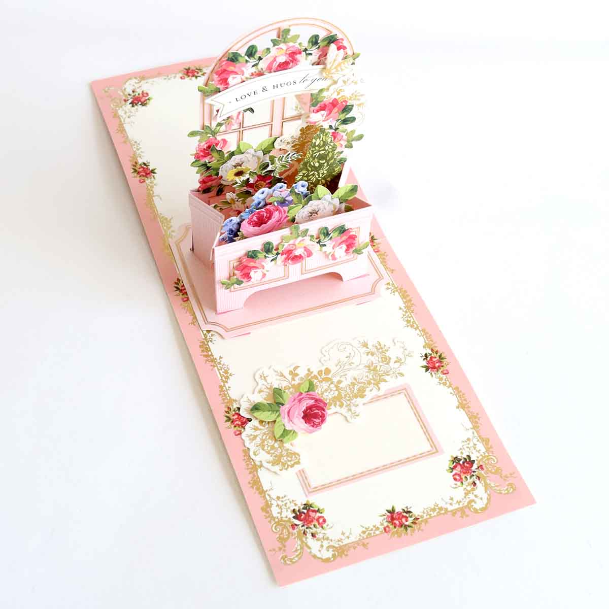 a card with a flower box inside of it.