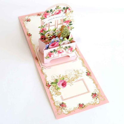 a card with a flower box inside of it.