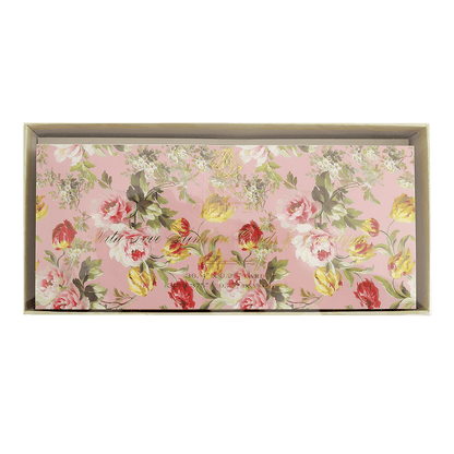 a pink floral wall hanging with a green background.