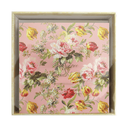 a pink floral wall hanging with a white frame.